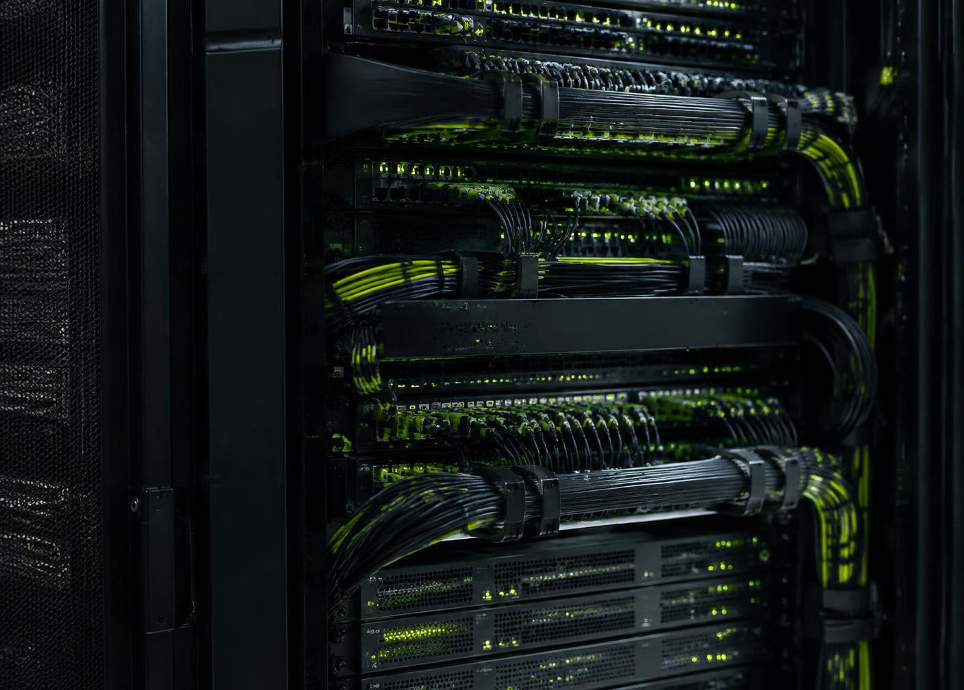 Server rack in a data center with neatly bundled network cables and green status lights